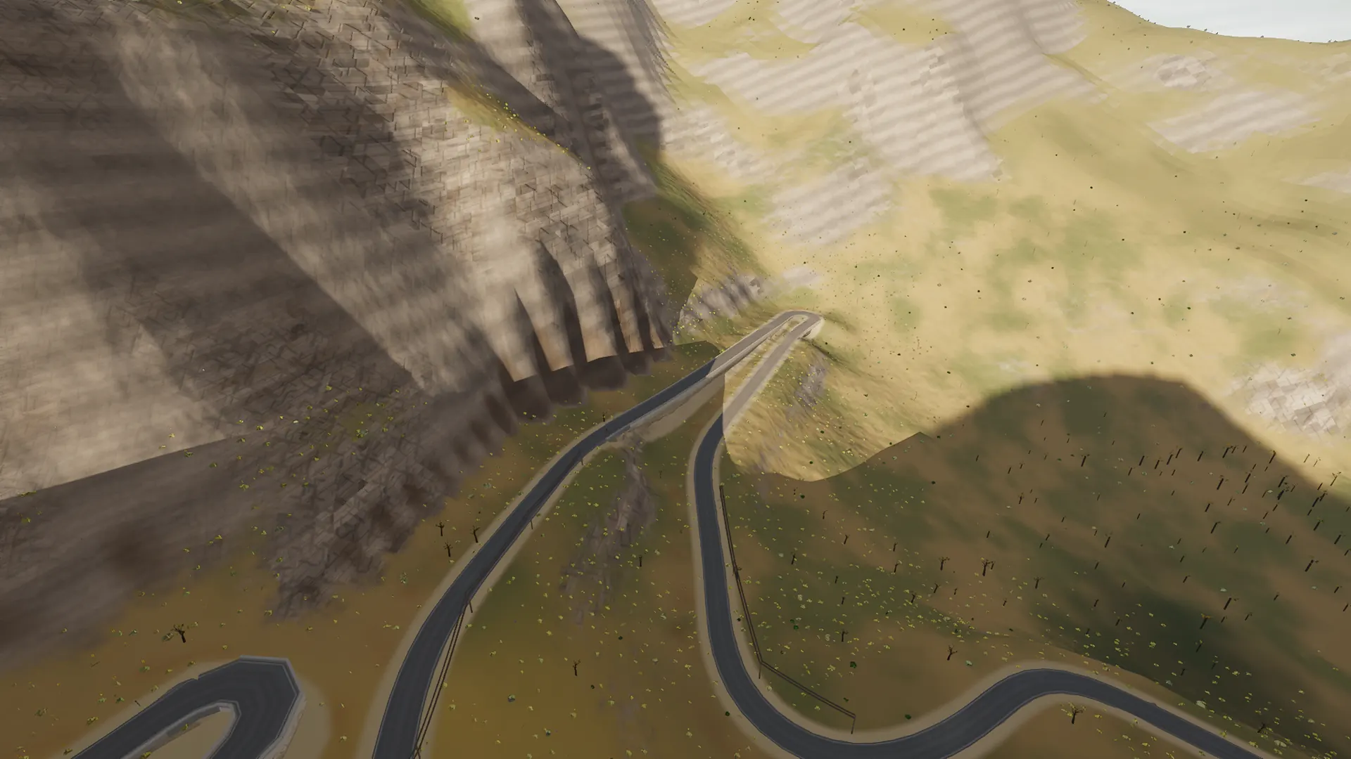 In-game aerial view of the stacked hairpins below Coll dels Reis on the Sa Calobra road